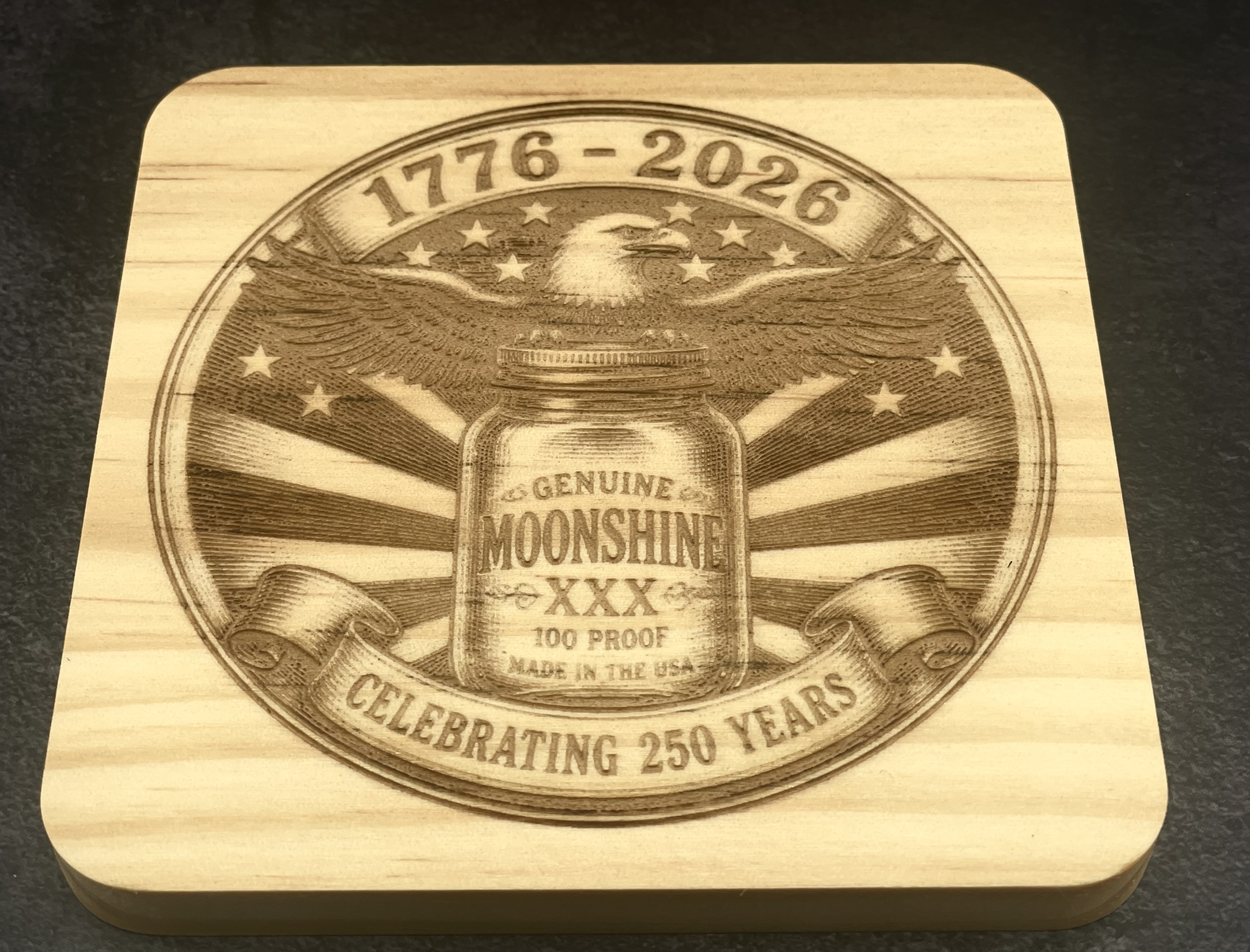 Genuine Moonshine XXX wood coaster with 1776-2026 eagle design, laser engraved